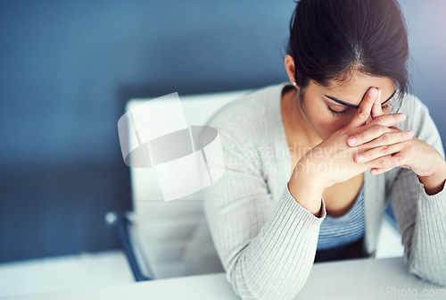 Image of Business woman, stress and tired in office with hands, worried and anxiety at desk at startup. Young businesswoman, burnout and headache with anxiety, frustrated or financial crisis in workplace