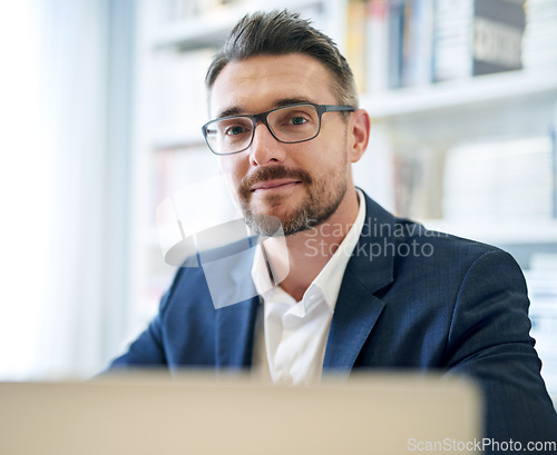 Image of Portrait, corporate and a businessman with a laptop in an office for an email or online communication. Smile, career and a mature employee with a computer for remote work and connection in a house