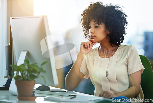 Image of Thinking, computer and woman employee reading information or email online, internet or web in an office. Young, desk and person or receptionist contemplating a project in an agency or startup