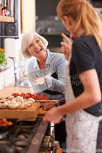 Image of Woman, grandmother and cooking together in kitchen or teach recipe, prepare dinner or cook lunch with family. Senior mother, girl and conversation in home or talking about food or healthy vegetables