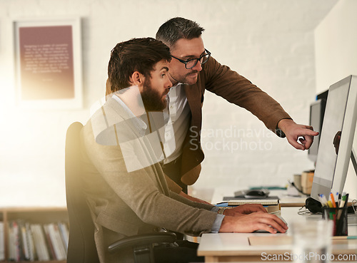 Image of Creative businessman, teamwork and coaching intern on computer in web design, UX or UI at the office. Man designer training staff or student on PC for team support, help or startup at the workplace