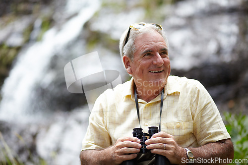 Image of Binoculars, happy man and forest or mountains thinking of journey, outdoor adventure and carbon footprint tourism. Senior person with gear for birdwatching experience or search nature by waterfall