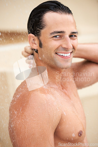 Image of Man, shower and water drop with smile, portrait and bathroom for hygiene, self care and morning for skin routine. Young guy, body cleaning and healthy for skincare, wellness or happiness in apartment