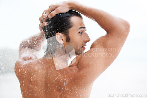 Image of Clean, back view of a man in the shower and health wellness indoors. Cleaning in bathroom, muscular or wellbeing and rearview of wet male person showering for refreshing hygiene protection or washing