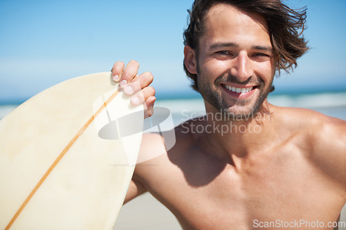 Image of Portrait, surfboard and a man in the sea at the beach for surfing while on summer holiday or vacation. Face, smile and sports with a happy young male surfer shirtless outdoor by the ocean for a surf