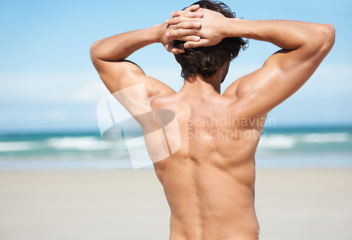 Image of Beach, travel and back of a man on a vacation, adventure or weekend trip on tropical island. Relax, freedom and male person standing and watching the ocean water while on summer holiday in Australia.