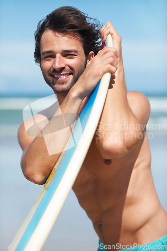 Image of Portrait, surf and a man in the ocean at the beach with his surfboard while on summer vacation or holiday. Face, smile and body with a happy young male surfer shirtless outdoor by the sea for surfing