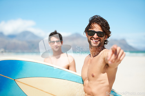 Image of Beach, pointing and man surfing friends outdoor together for summer vacation or holiday trip overseas. Surf, sea or travel with a young male surfer in sunglasses and friend bonding on an ocean coast