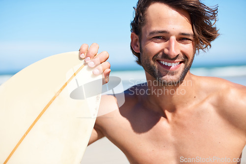 Image of Portrait, surfing and a man in the ocean at the beach for surfing while on summer holiday or vacation. Invite, come and join with a happy young male surfer holding a surfboard outdoor by the sea