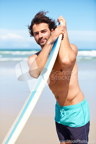 Image of Portrait, surfboard and a man at the beach for surfing while on summer holiday or vacation for sports. Surf, sport and body with a young male surfer shirtless outdoor by the sea for an active hobby