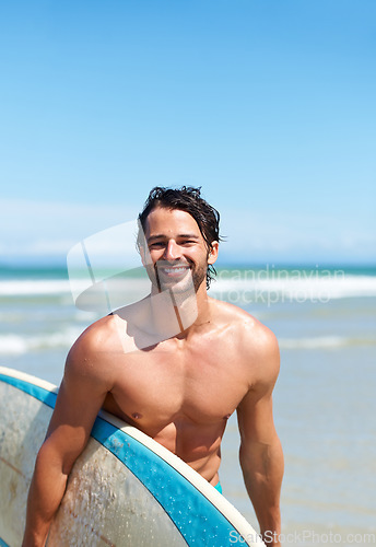 Image of Portrait, surfboard and a man laughing at the beach in the ocean while surfing on summer vacation or holiday. Smile, body or fun with a happy young male surfer shirtless outdoor by the sea for a surf