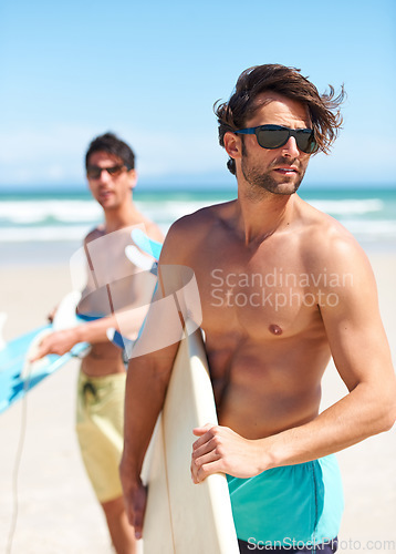 Image of Beach, summer and man surfer friends outdoor together for travel, vacation or holiday trip overseas. Surf, sea or fun with a young male and friend surfing in sunglasses bonding on an ocean coast