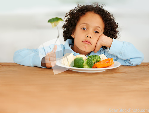 Image of Bored, upset and child eating vegetables for a healthy, growth and wellness diet at his home. Nutrition, dinner and sad boy kid at the dining table with produce lunch, snack or meal at his house.