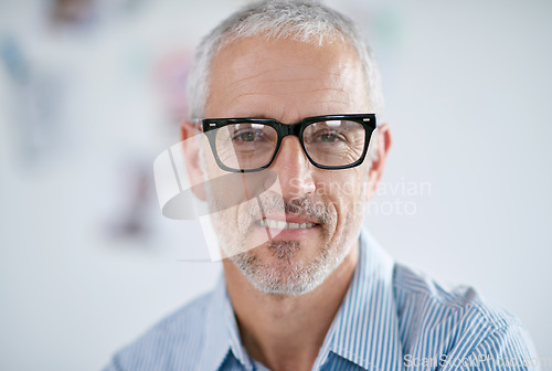 Image of Portrait, glasses and leadership with a business man in the office for corporate or professional work. Face, eyewear and management with a senior leader or CEO in a workplace on a blurred background