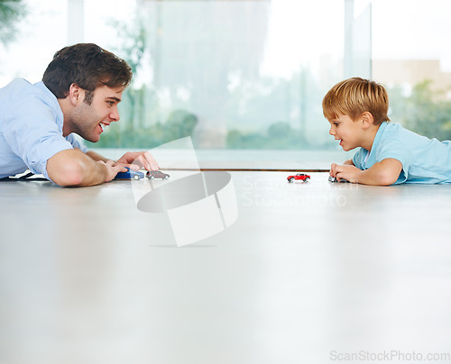 Image of Playing, happy and a father and child with cars for bonding, quality time and happiness. Smile, family and a dad with a boy kid and toys for a race or competition on the floor of a house together