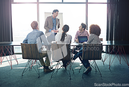 Image of Meeting, presentation and business with a man CEO in the boardroom for training, coaching or education. Workshop, management or leadership with a mature male employee talking to his team in an office