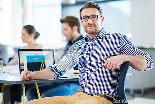 Image of Smile, desk and portrait of a businessman at work for web design, creativity or expert at an agency. Happy, creative and a mature designer with a laptop for a website, email or graphic professional