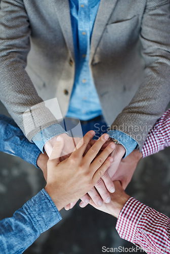 Image of Collaboration, top view and hands together for cooperation, team building or solidarity. Teamwork, hand huddle and group of people with motivation, trust or support for community goals in partnership