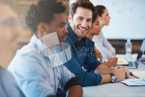 Image of Portrait, happy and a business man in the boardroom with his team during a meeting for planning. Smile, strategy or collaboration with a male employee and colleagues in the office for a seminar