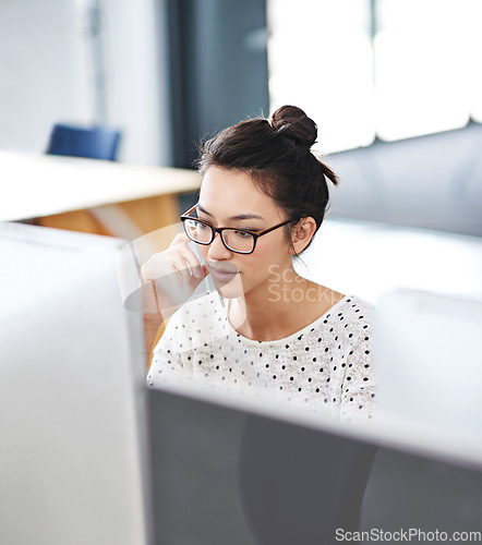 Image of Focus, computer and business woman in office for research, website and designer. Thinking, entrepreneur and creative with female employee in digital agency for technology, professional and startup