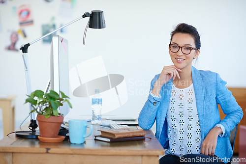 Image of Business woman, portrait and smile at creative startup, confidence with empowerment in workplace. Confidence, success and career mindset, female professional at desk with ambition at advertising firm