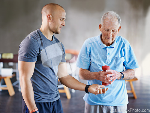 Image of Physiotherapist, senior man patient and weight training for health and wellness therapy in retirement. Healthcare, physio and workout for recovery with dumbbell for medical rehab and elderly person