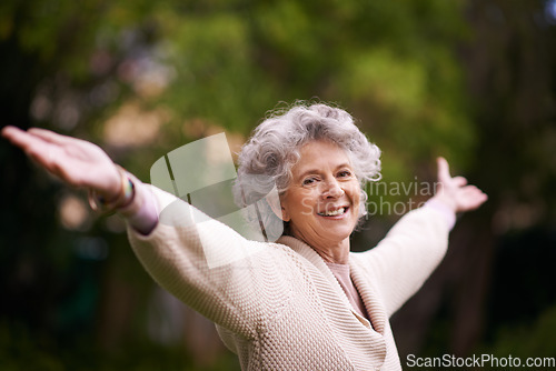 Image of Portrait, happiness and senior woman with open arms in backyard garden or lady with a happy smile on face, celebrate life. Healthy, smiling pensioner stretching with freedom and success in retirement