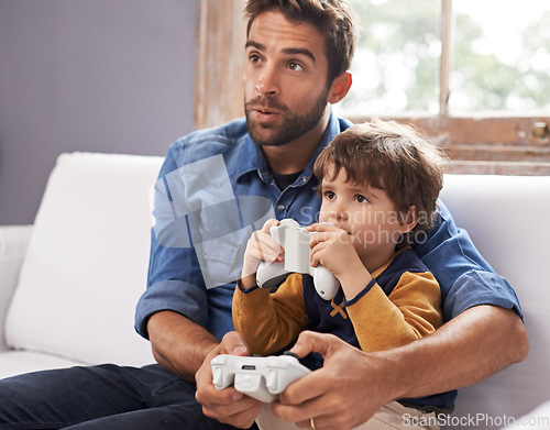 Image of Gaming, father and son on a sofa, playing and loving at home, quality time and bonding. Family, dad or male child on a couch, controller or playful with fun, relax and connection with joy or cheerful
