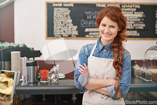 Image of Portrait, woman and barista with arms crossed, coffee shop and startup success with skills. Face, female entrepreneur and employee with leadership, business development and profit growth in a cafe