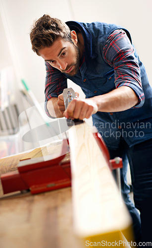 Image of Carpenter, wood and furniture with man in workshop for building, manufacturing and creative. Planning, industry and woodworker with handyman and plane in home garage for builder, lumber and design