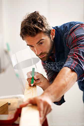 Image of Man, wood and pencil for measure for construction, home development and building renovation. Carpenter, maintenance employee and male repairman worker on a contractor job of builder working in house