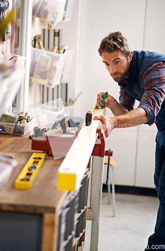 Image of Worker man, wood and tape measure for construction, home development and building renovation. Carpenter, maintenance employee and male repairman on a contractor job of builder working in house