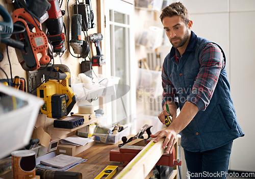 Image of Man, wood and tape measure for construction, home development and building renovation. Carpenter, maintenance employee and male repairman worker on a contractor job of builder working in house