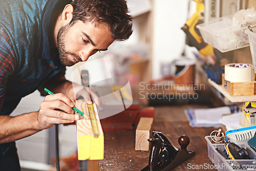 Image of Carpenter, wood and drawing with man in workshop for building, manufacturing and creative. Planning, industry and woodworker with handyman measuring on workbench for builder, lumber and maintenance