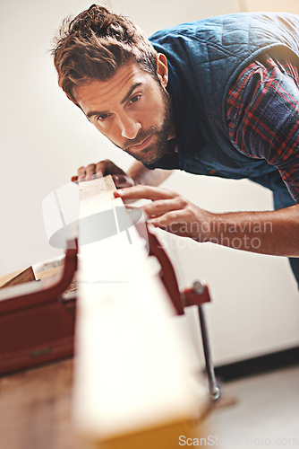 Image of Carpenter, wood and design with man in workshop for building, manufacturing and creative. Planning, industry and woodworker with handyman measuring on workbench for builder, lumber and maintenance