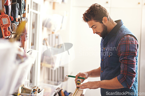 Image of Carpenter, wood and measure with man in workshop for building, manufacturing and creative. Planning, industry and woodworker with handyman measuring on workbench for builder, lumber and maintenance