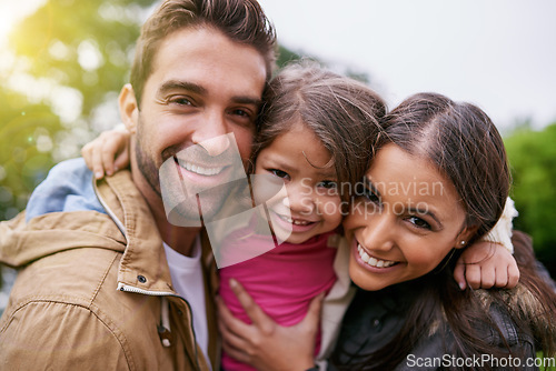 Image of Family, closeup and park hug portrait with a mom, dad and girl together with happiness and smile. Outdoor, face and vacation of mother, father and kid with bonding, love and child care in nature