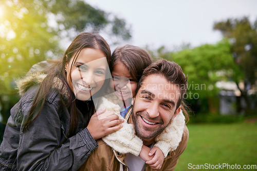 Image of Family, piggy back and park portrait with a mom, dad and girl together with happiness and smile. Outdoor, face and summer vacation of a mother, father and kid with bonding, parent love and child care