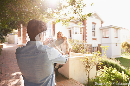 Image of Father take picture of mother and girl by home for memories, social media post and bonding. New house, photograph and dad taking photo of mom and child for happiness, relaxing and smile on property