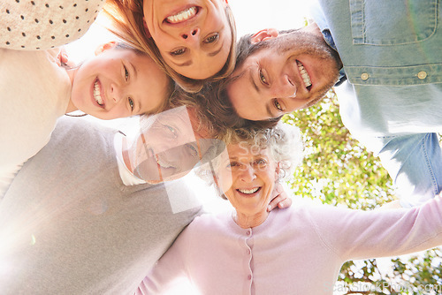 Image of Faces portrait, circle and happy family hug, grandparents and parents bonding with kid child in nature park. Care, solidarity or below view of people smile for natural sunshine, love support or peace