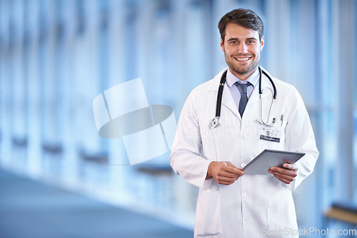 Image of Portrait, healthcare and tablet with a doctor man standing in a hospital corridor for research or insurance. Medical, trust and technology with a male medicine professional in a clinic for health