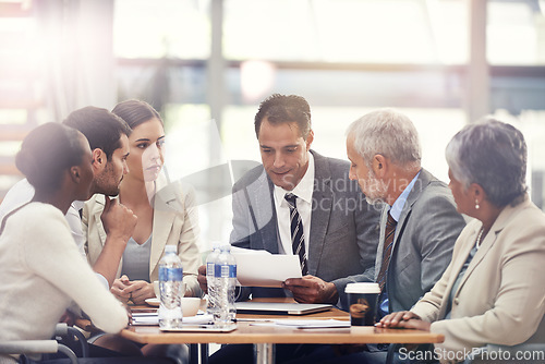 Image of Planning, talking and business people with a report in a meeting for financial strategy or investment. Teamwork, diversity and employees in accounting with paper for results on investing or economy