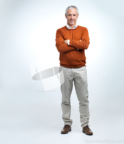 Image of Mature man, portrait and arms crossed in a studio with modern style, fashion and smile. Happy, senior and old male person with white background with confidence and casual jersey alone with joy