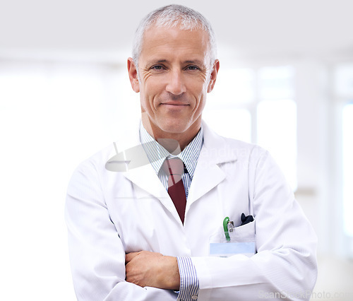 Image of Healthcare, portrait of man doctor with arms crossed and in a hospital. Medical health wellness, specialist or stand and confident professional mature male surgeon or nurse at clinic for support