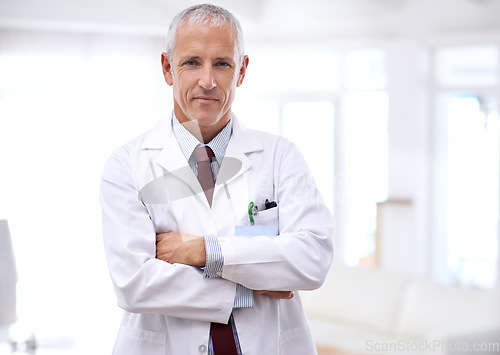 Image of Senior man, doctor and portrait with arms crossed for health, wellness and helping in hospital. Mature healthcare expert, medic and professional with medical knowledge, experience and work in clinic