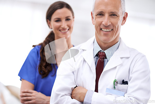 Image of Doctors, man and woman with smile, arms crossed or portrait for wellness, health or hospital. Mature healthcare expert, nurse and professional with medical knowledge, solidarity or teamwork in clinic