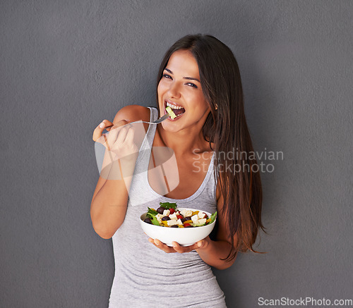 Image of Woman is eating a salad, healthy food and nutrition, portrait and vegetables isolated on wall background. Happy, vegan and health with wellness, diet and female model to lose weight with mockup space