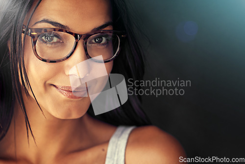 Image of Woman, face and smile with glasses and vision with designer frame with prescription lens on studio background. Portrait, eye care and female model with fashion eyewear, optometry and mockup space