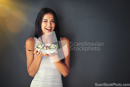 Image of Woman wink with salad, healthy food and nutrition, portrait and vegetables isolated on wall background. Happy, body and health with wellness, diet and female model to lose weight with mockup space