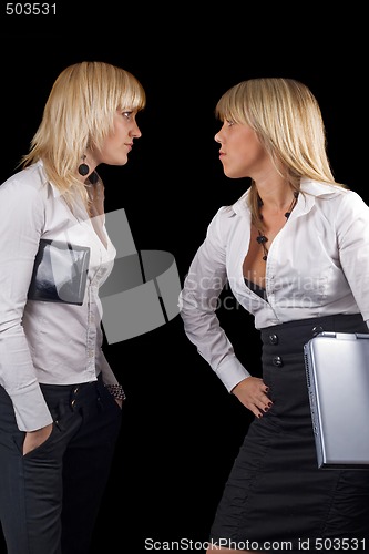 Image of Two young businesswomen. Isolated on black background